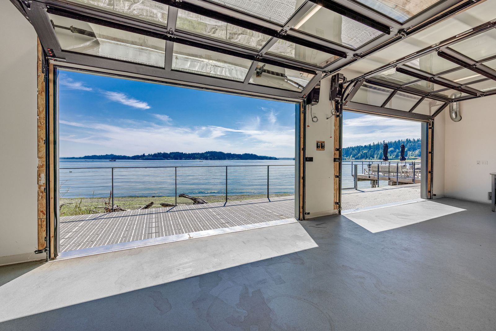 Warehouse with glass roll-up doors open to the water