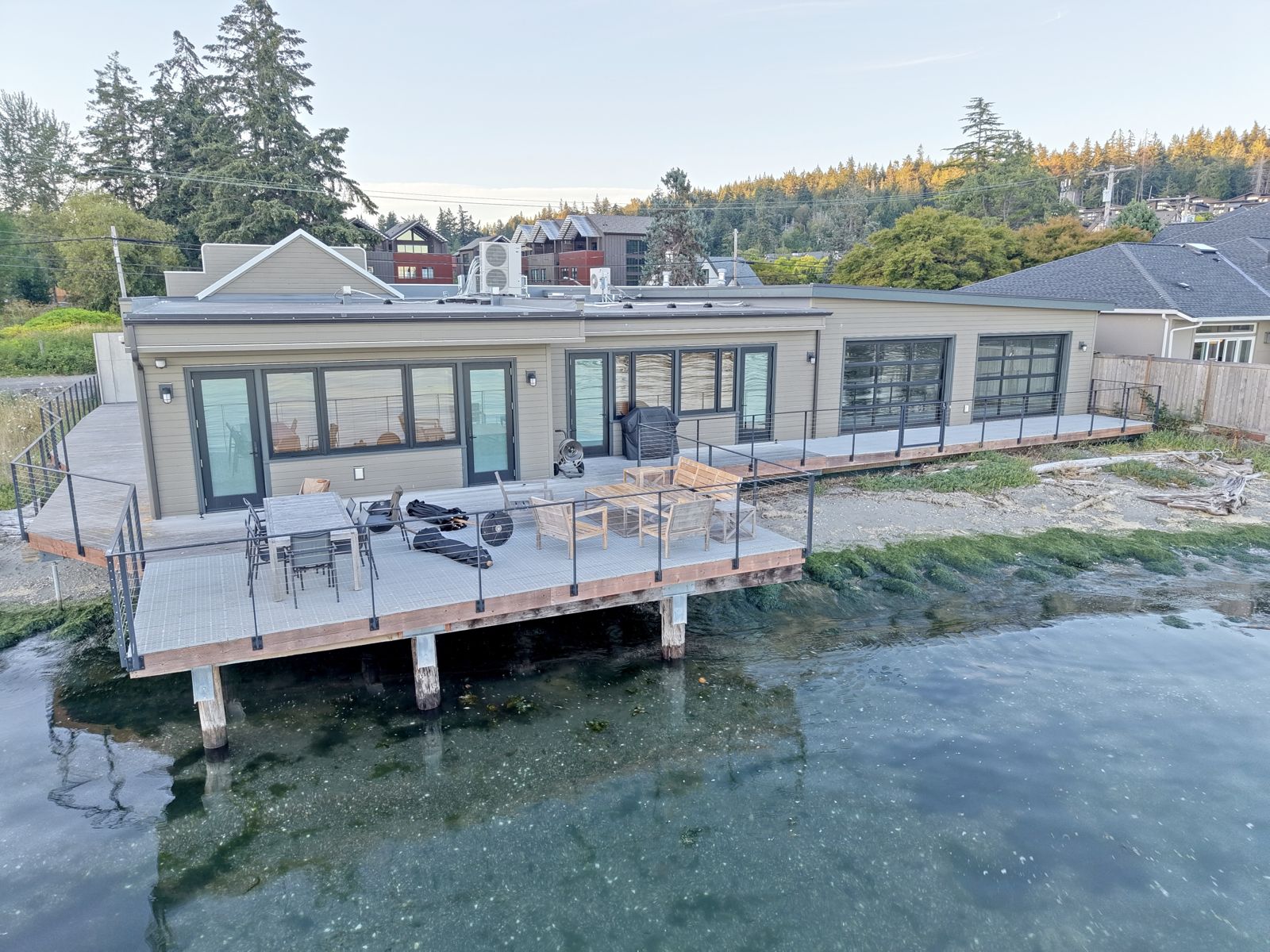The building from the water, deck and pilings